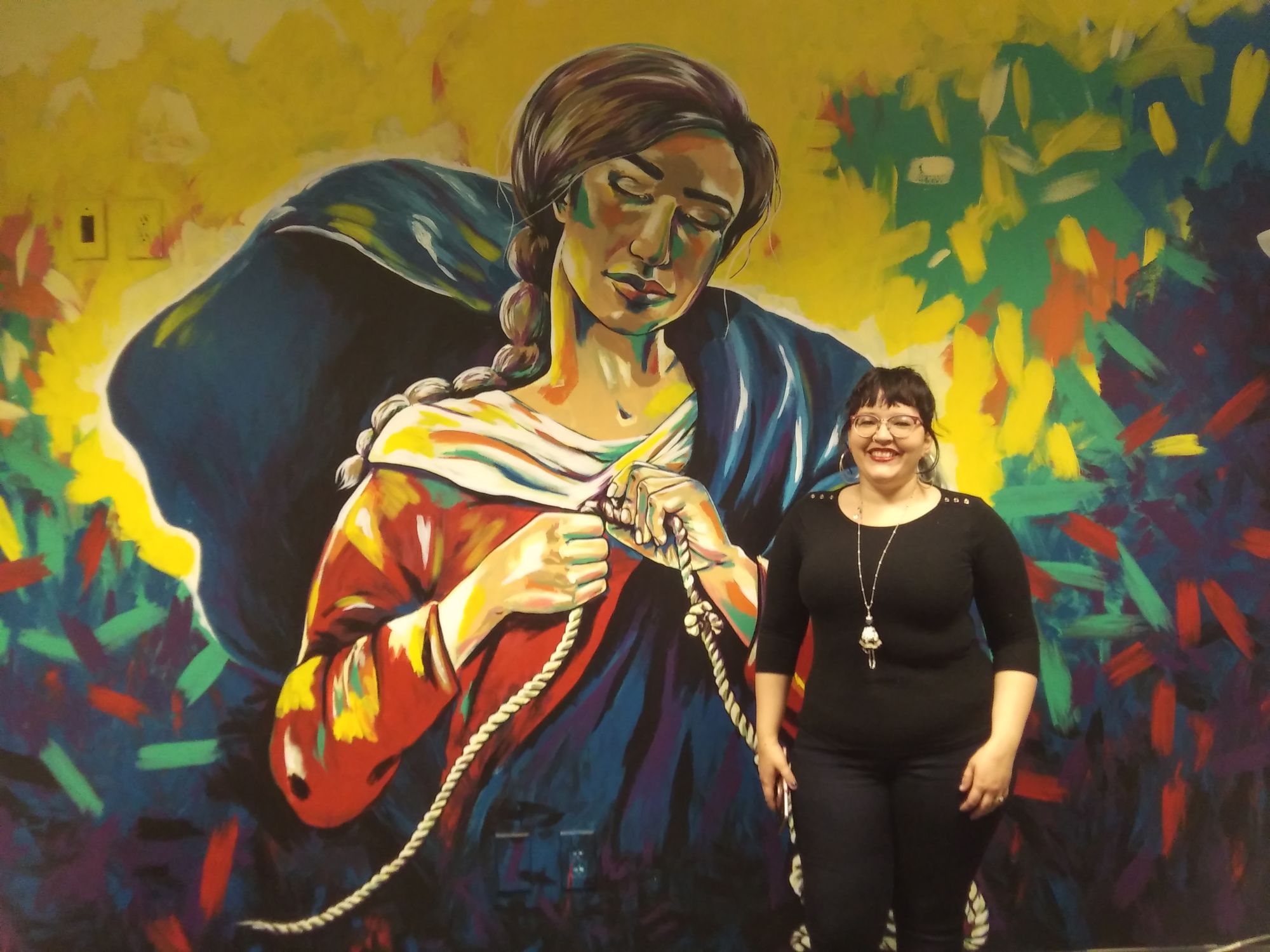 Local artist paints free hand mural on campus
