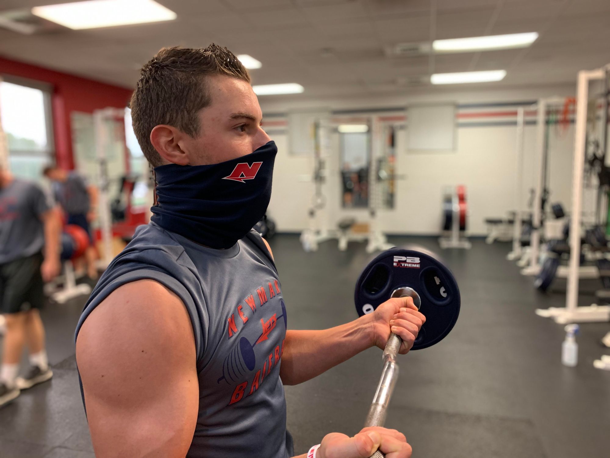 Newman weight room masking up, using new technology